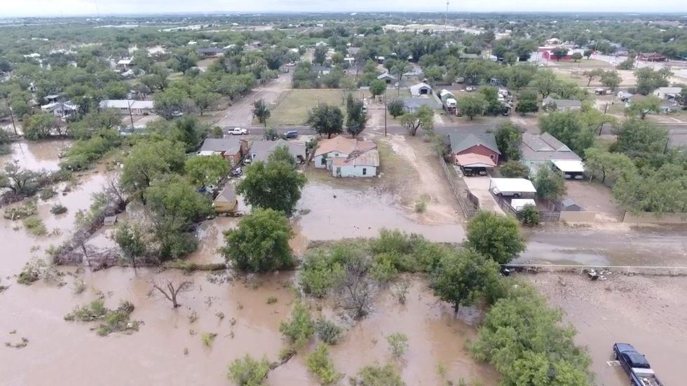 H\u200bouses flooded following torrential rains that unleashed flash floods along the Concho River in San Angelo