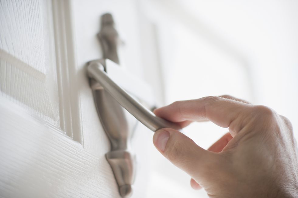 Hand about to use a door knocker
