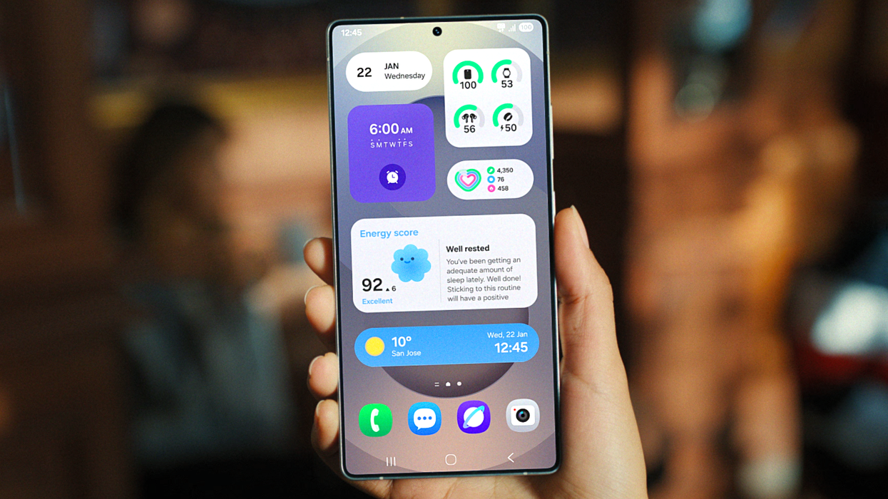 hand holding a Galaxy S smartphone showing the new user interface of One UI