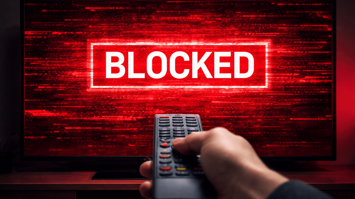 Hand holding a remote in front of a TV blocked from streaming content
