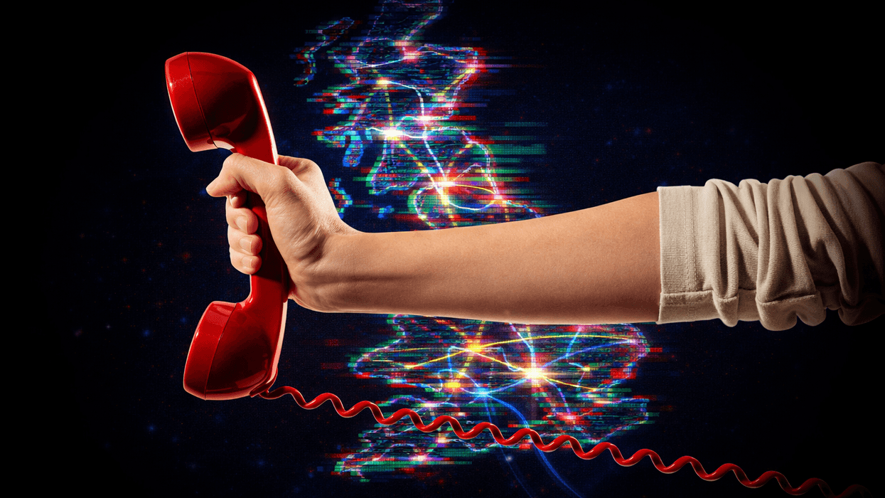 hand holding a traditional landline phone in red with a map of the UK with broadband connections in the background.