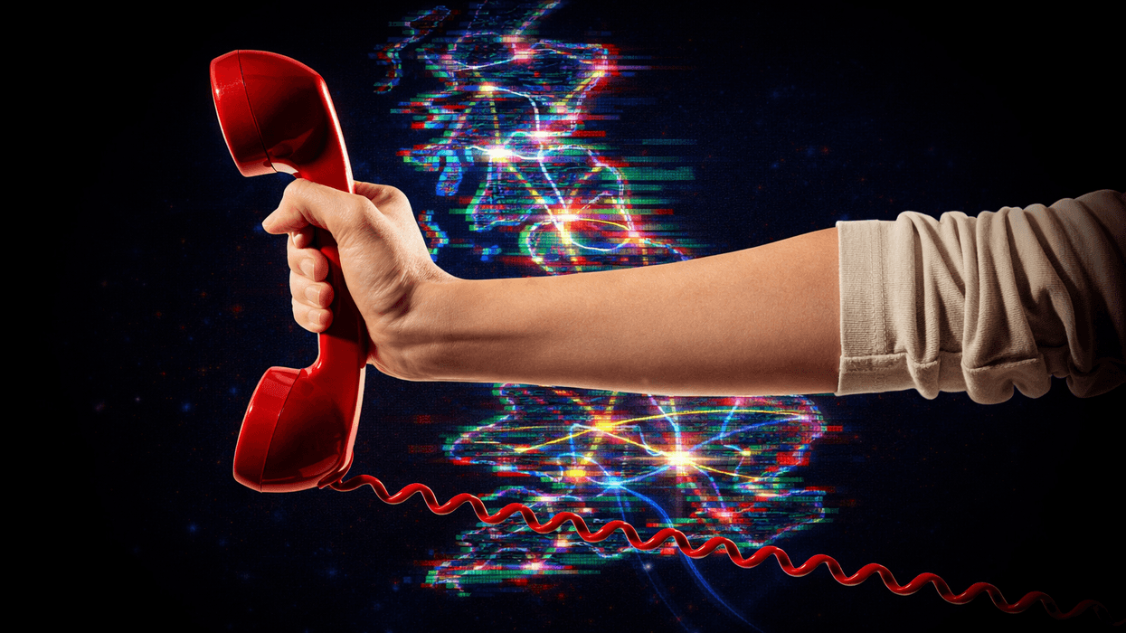 hand holding a traditional landline phone in red with a map of the UK with broadband connections in the background.