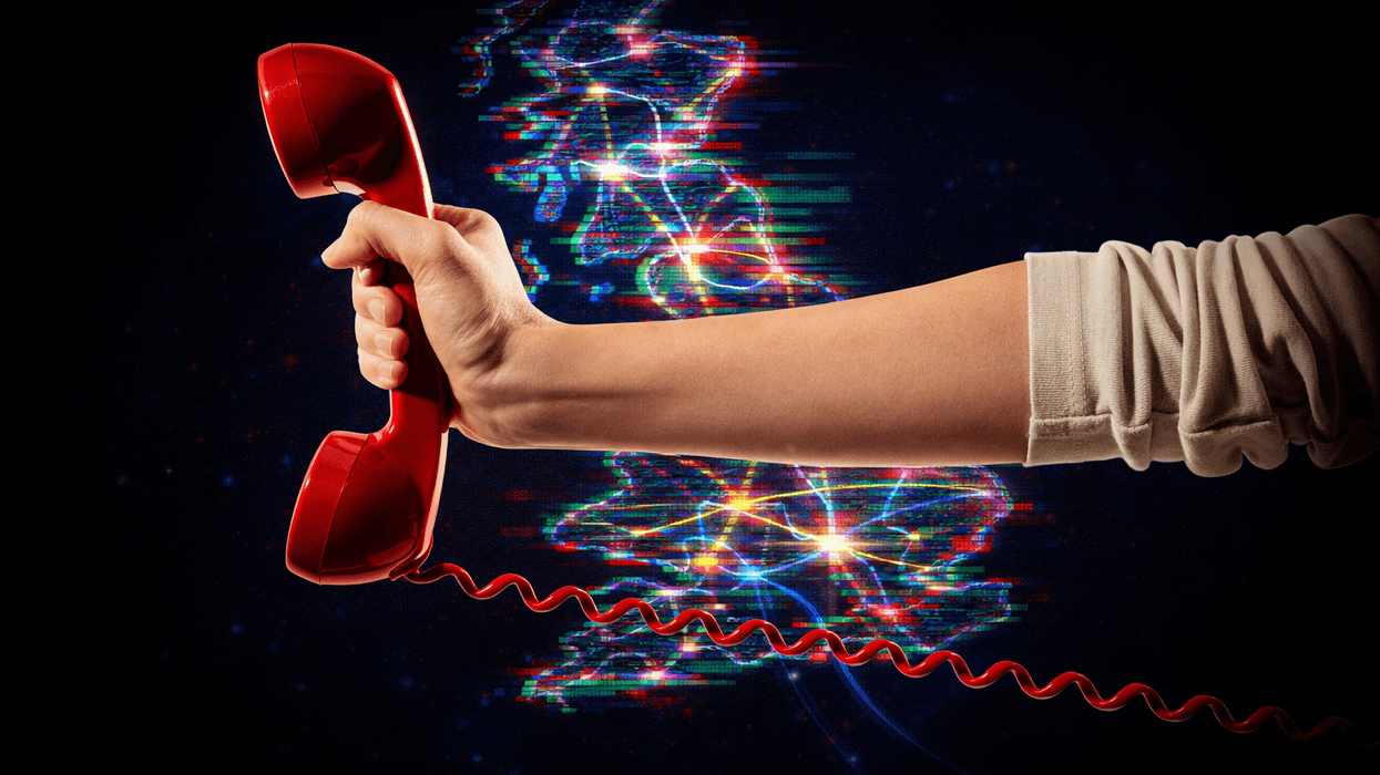 hand holding a traditional landline phone in red with a map of the UK with broadband connections in the background.