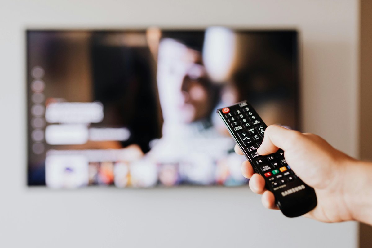 Hand holding a TV remote