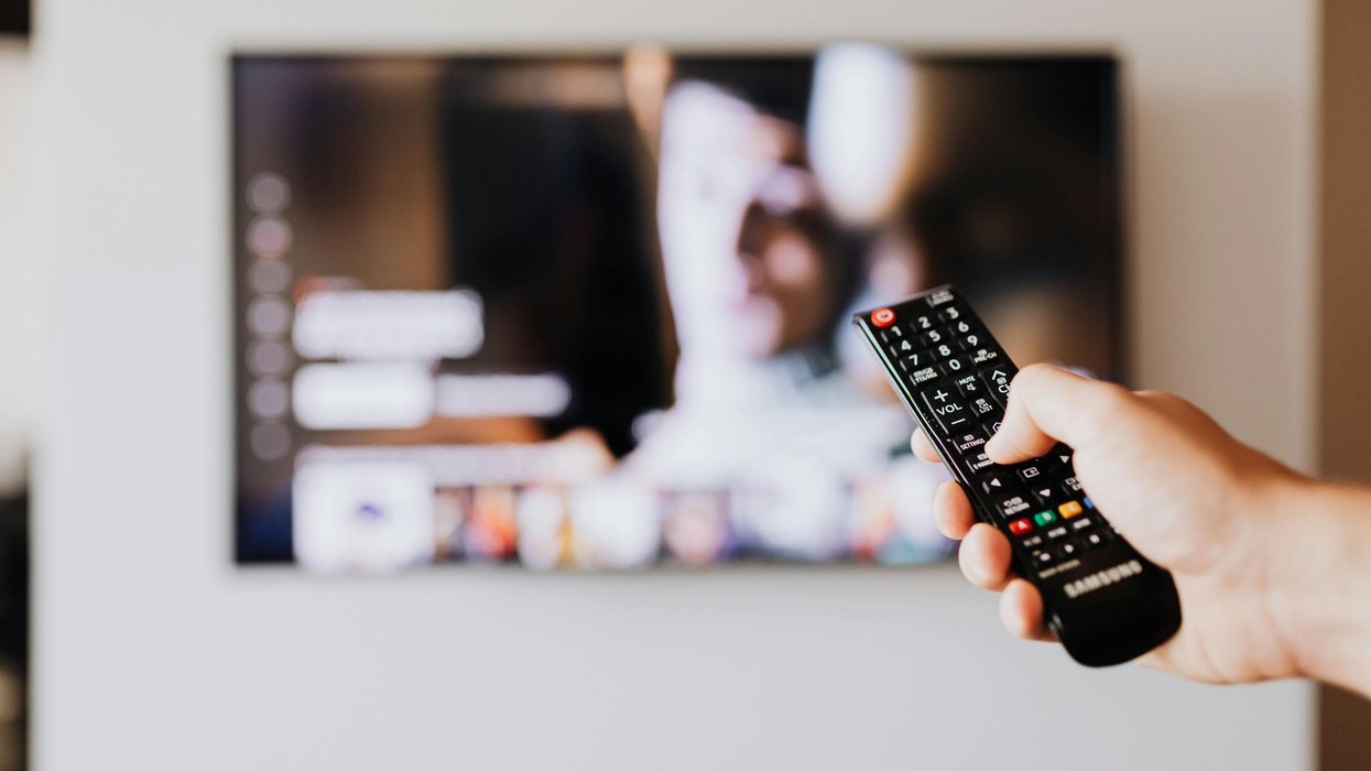 Hand holding a TV remote