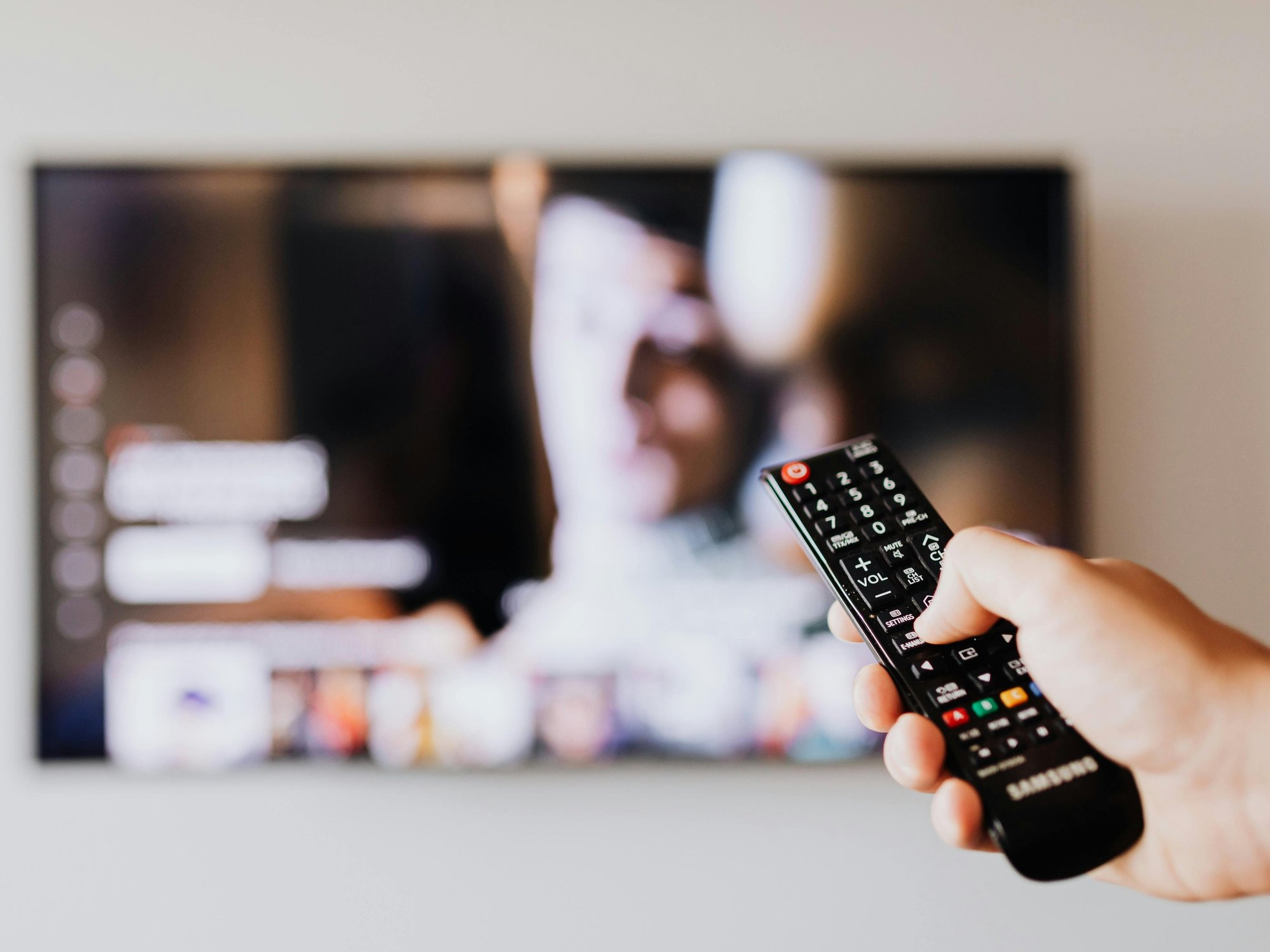 Hand holding a TV remote
