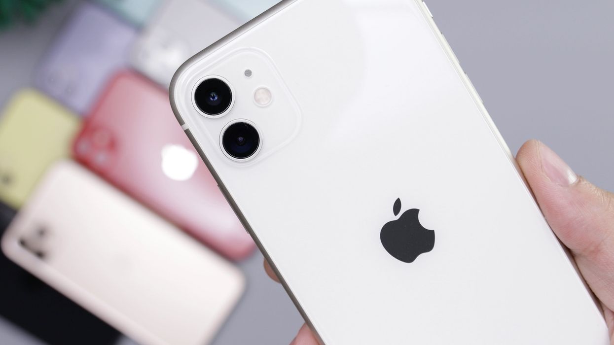 hand holding an iphone 11 with the other colours in the background