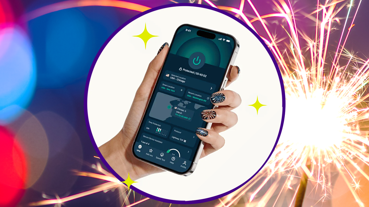 hand holding an iPhone running ExpressVPN with fireworks in the background