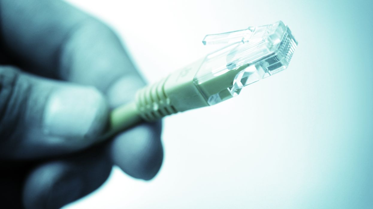 hand holding ethernet cable in a shade of blue