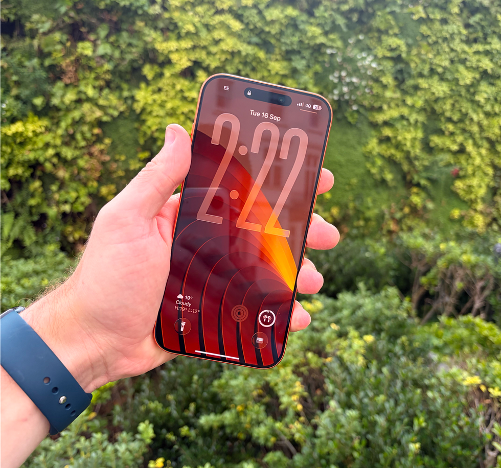 hand holding iPhone 17 pro max outside