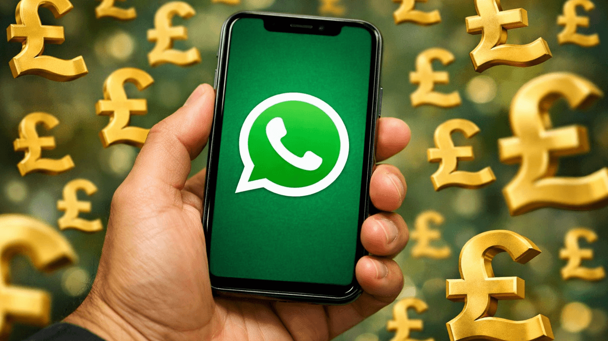 Hand holding mobile with WhatsApp British