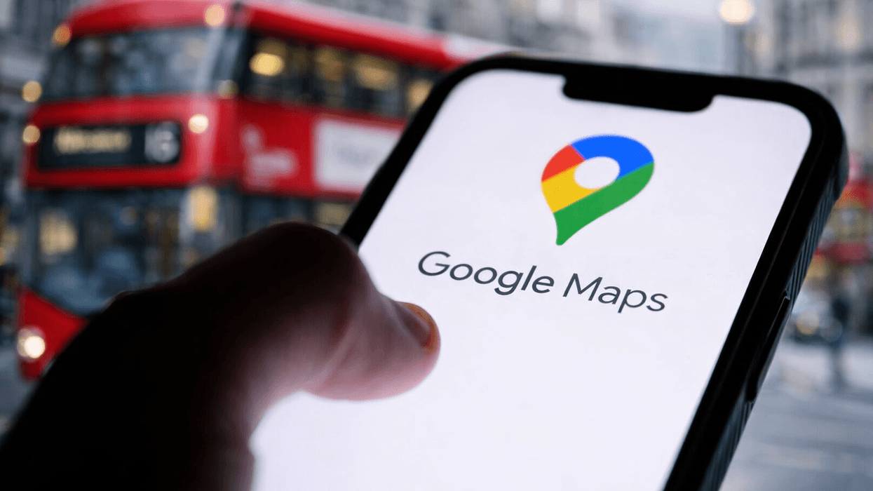 Hand holding phone with Google Maps on screen