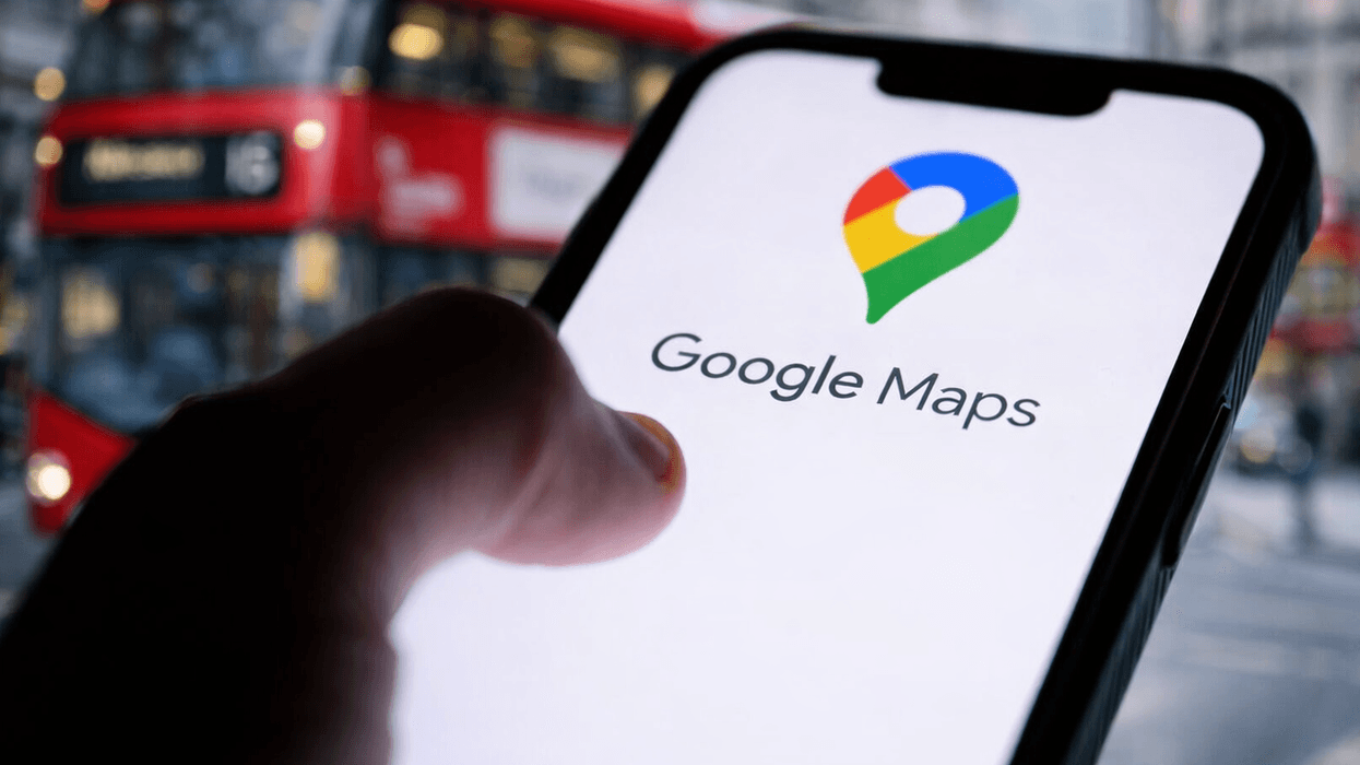 Hand holding phone with Google Maps on screen