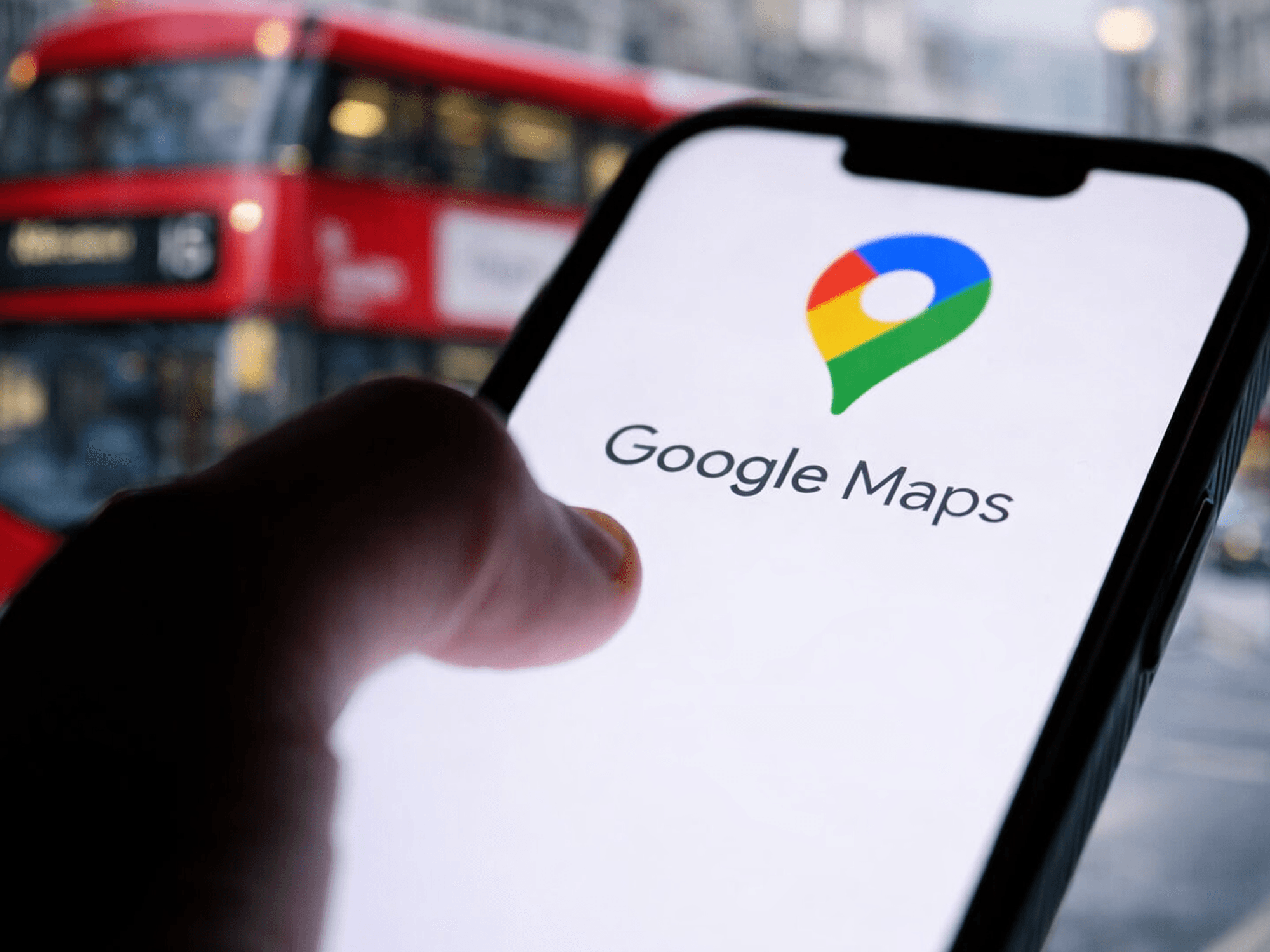 Hand holding phone with Google Maps on screen