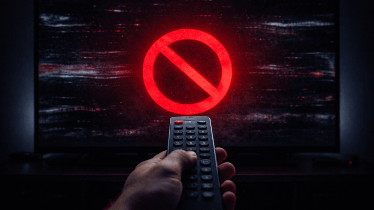 Hand holding remote controller in front of blocked TV