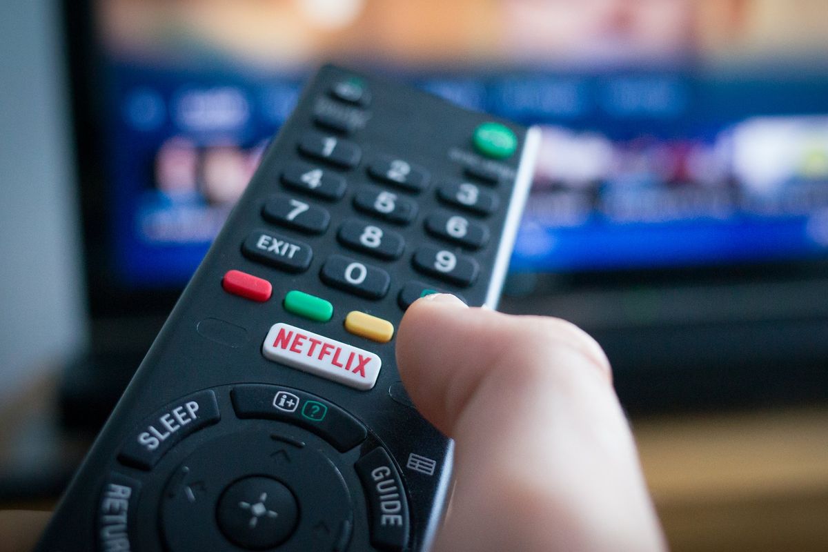 Hand holding remote with Netflix button