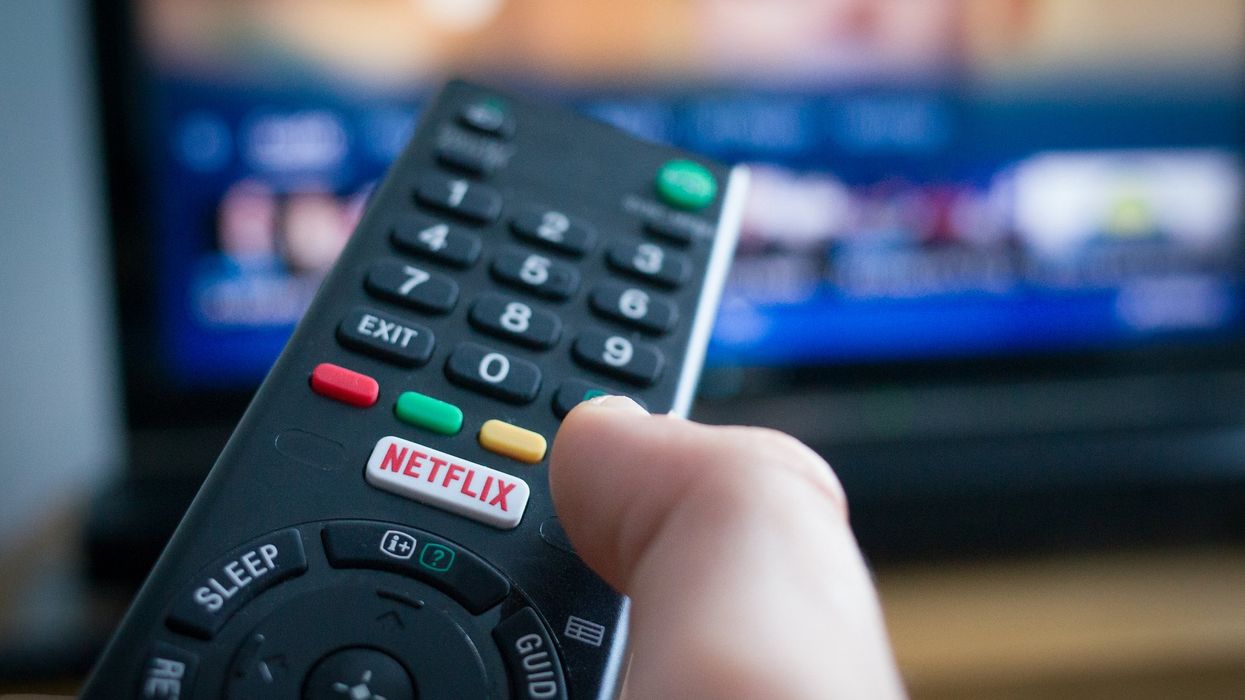 Hand holding remote with Netflix button