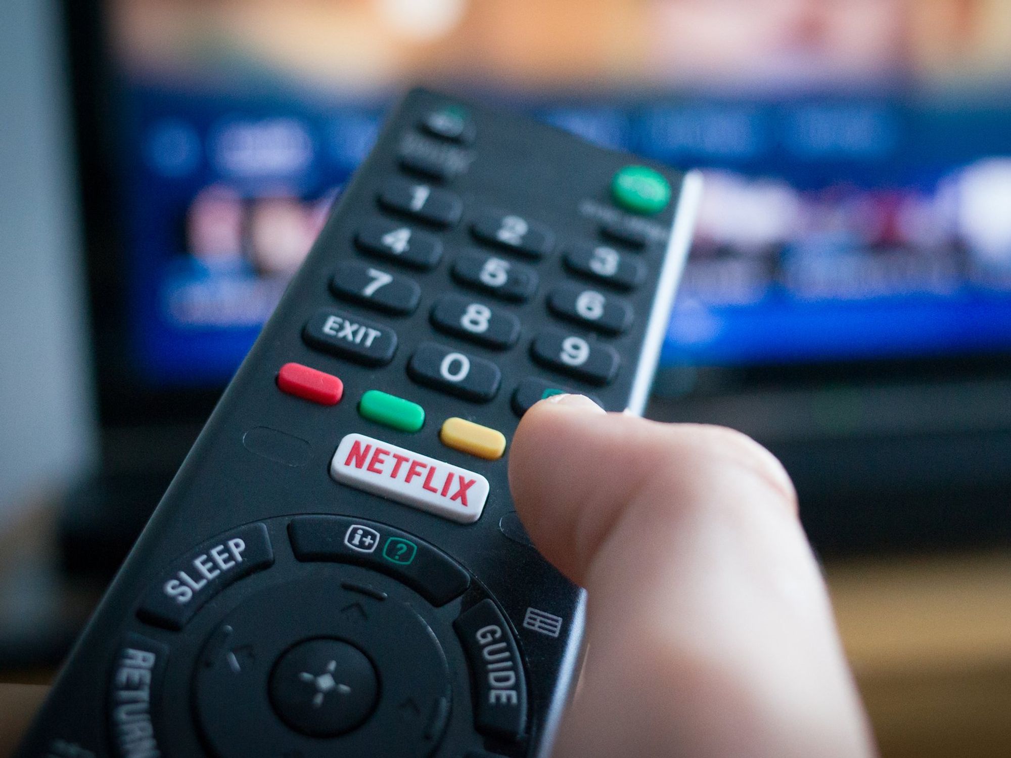 Hand holding remote with Netflix button