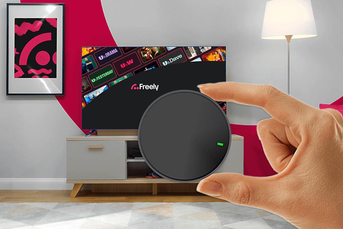 hand holding streaming puck with Freely in the background