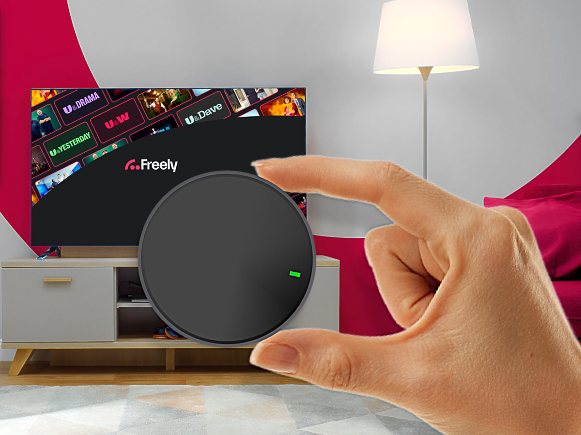 hand holding streaming puck with Freely in the background