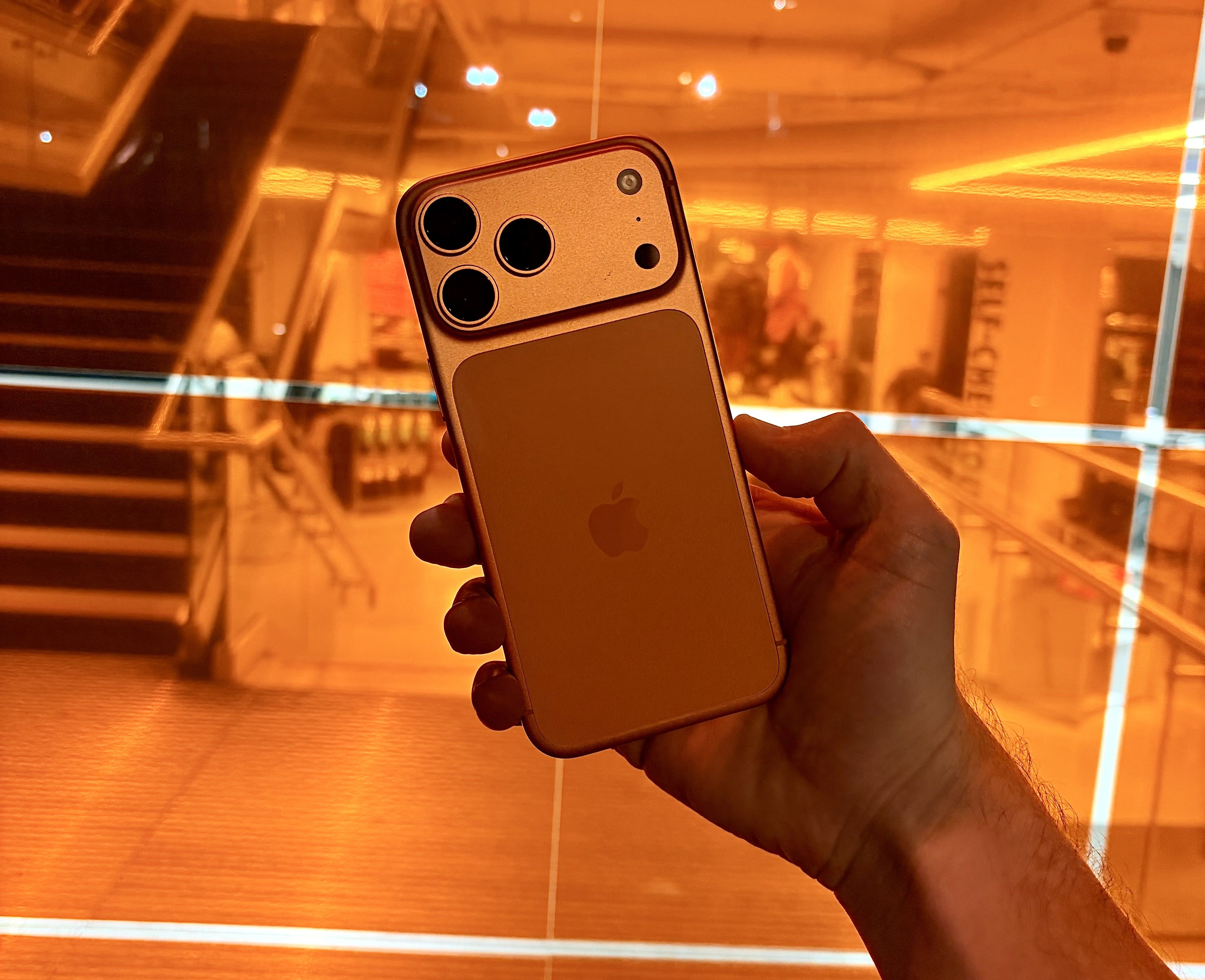 hand holding the Cosmic Orange iPhone 17 Pro Max