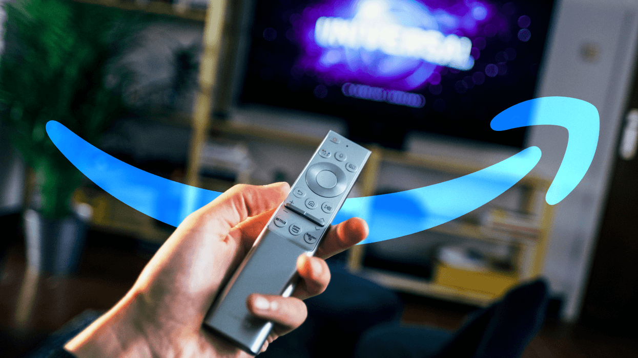 Hand holding TV remote with Amazon Prime logo