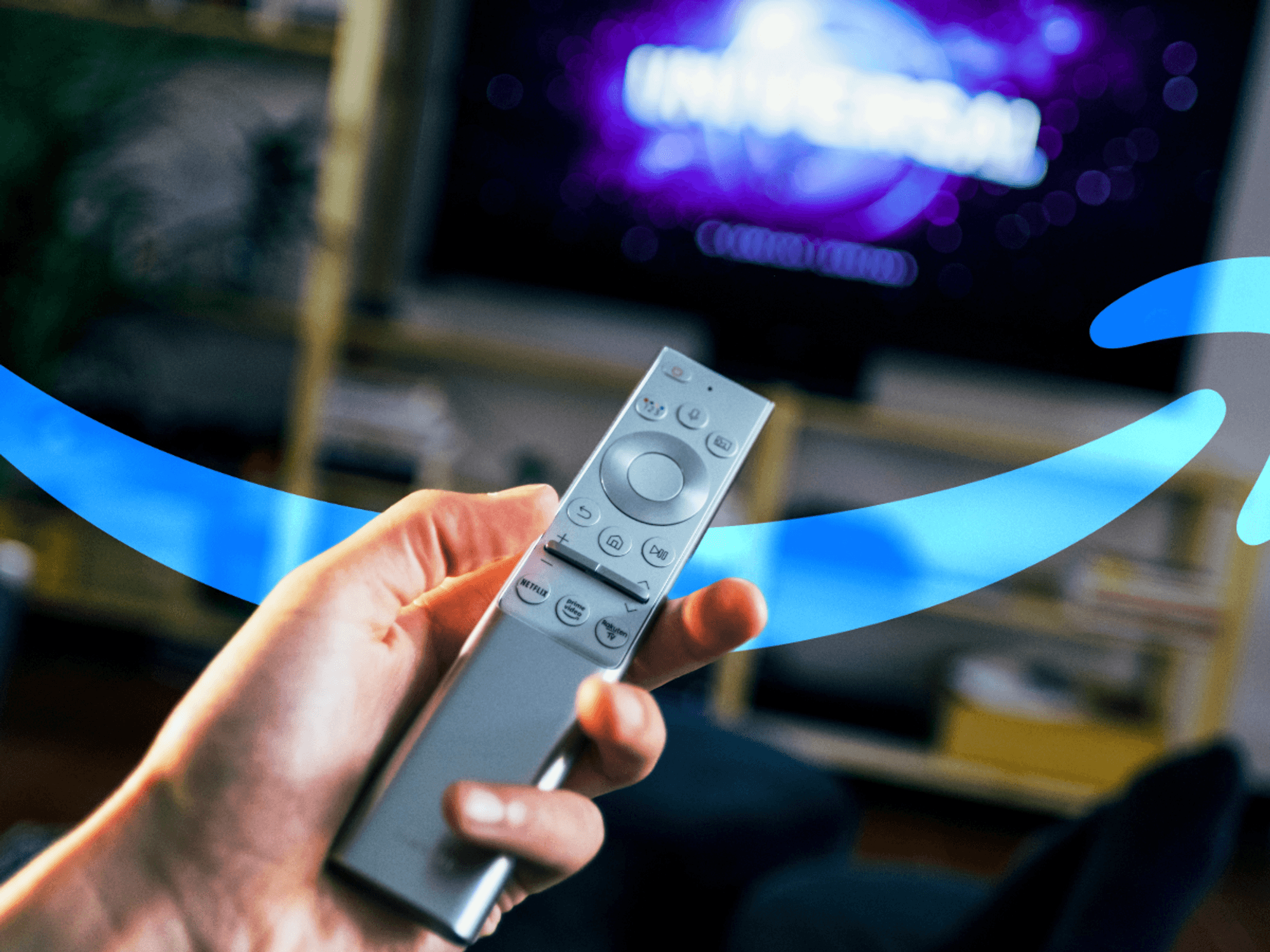 Hand holding TV remote with Amazon Prime logo