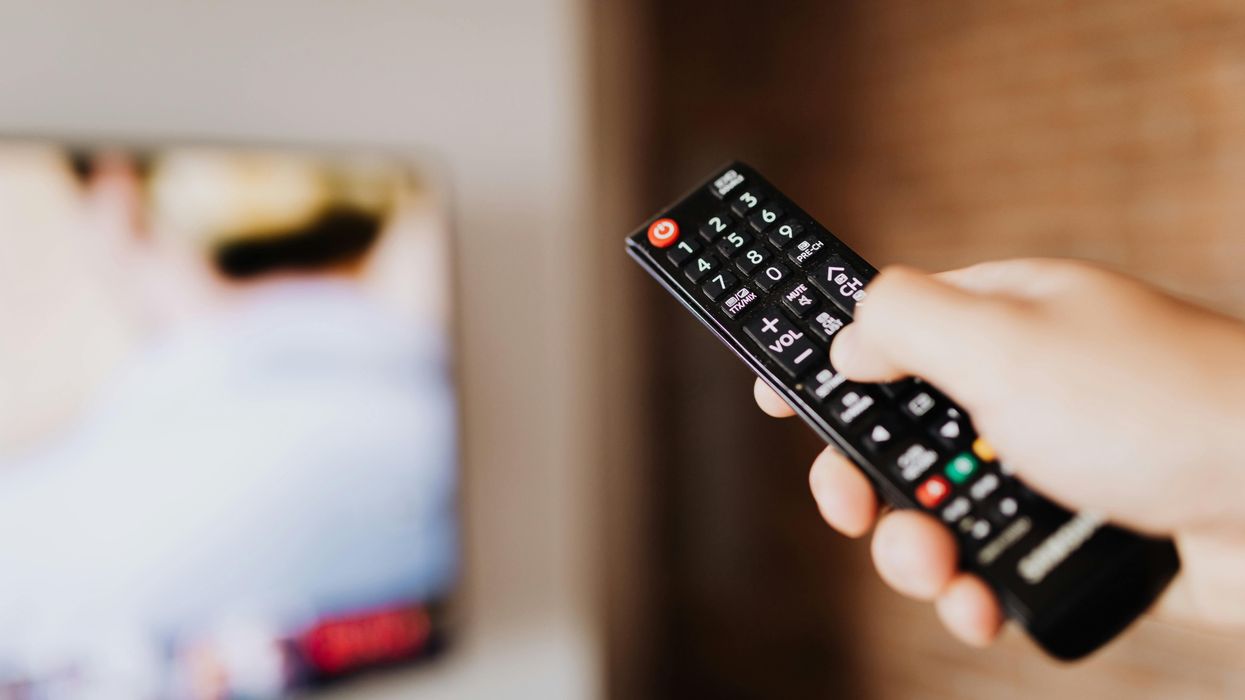 Hand holding TV remote