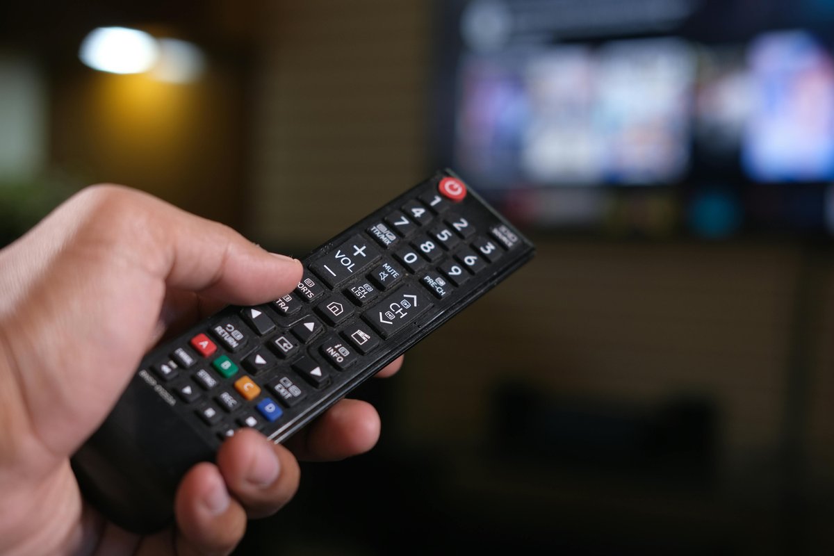 Hand holding TV remote