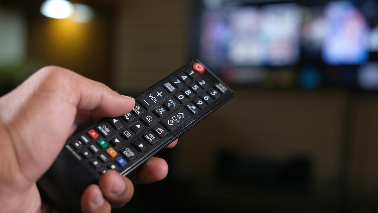 Hand holding TV remote