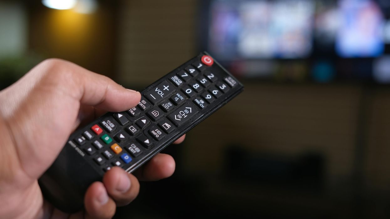 Hand holding TV remote