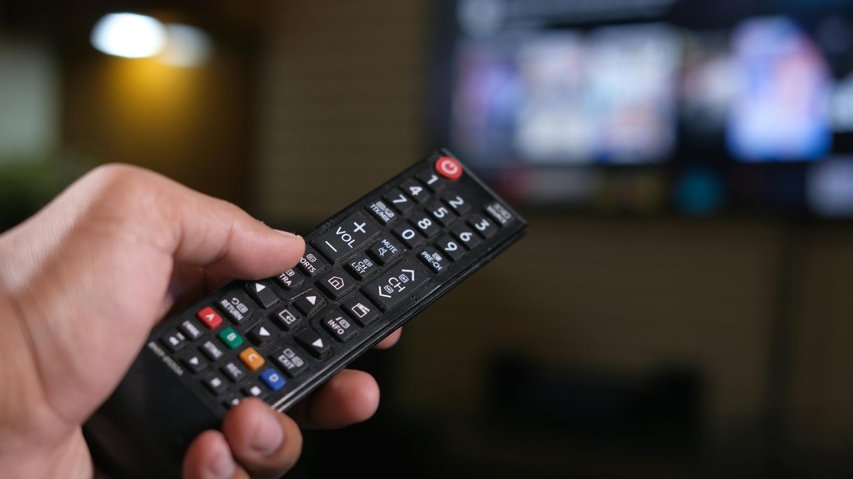 Hand holding TV remote