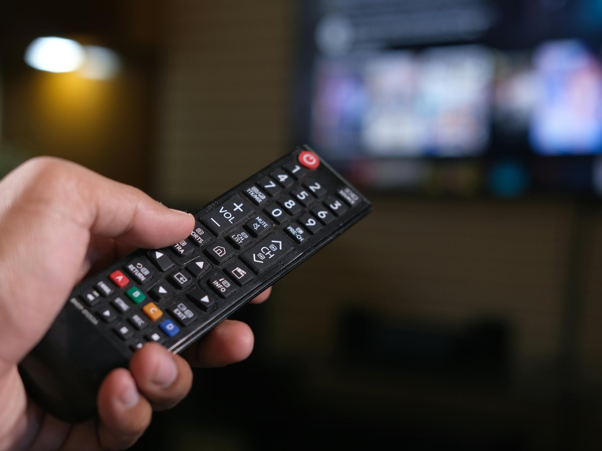 Hand holding TV remote