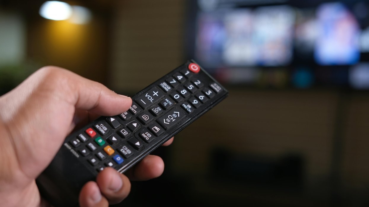 Hand holding TV remote