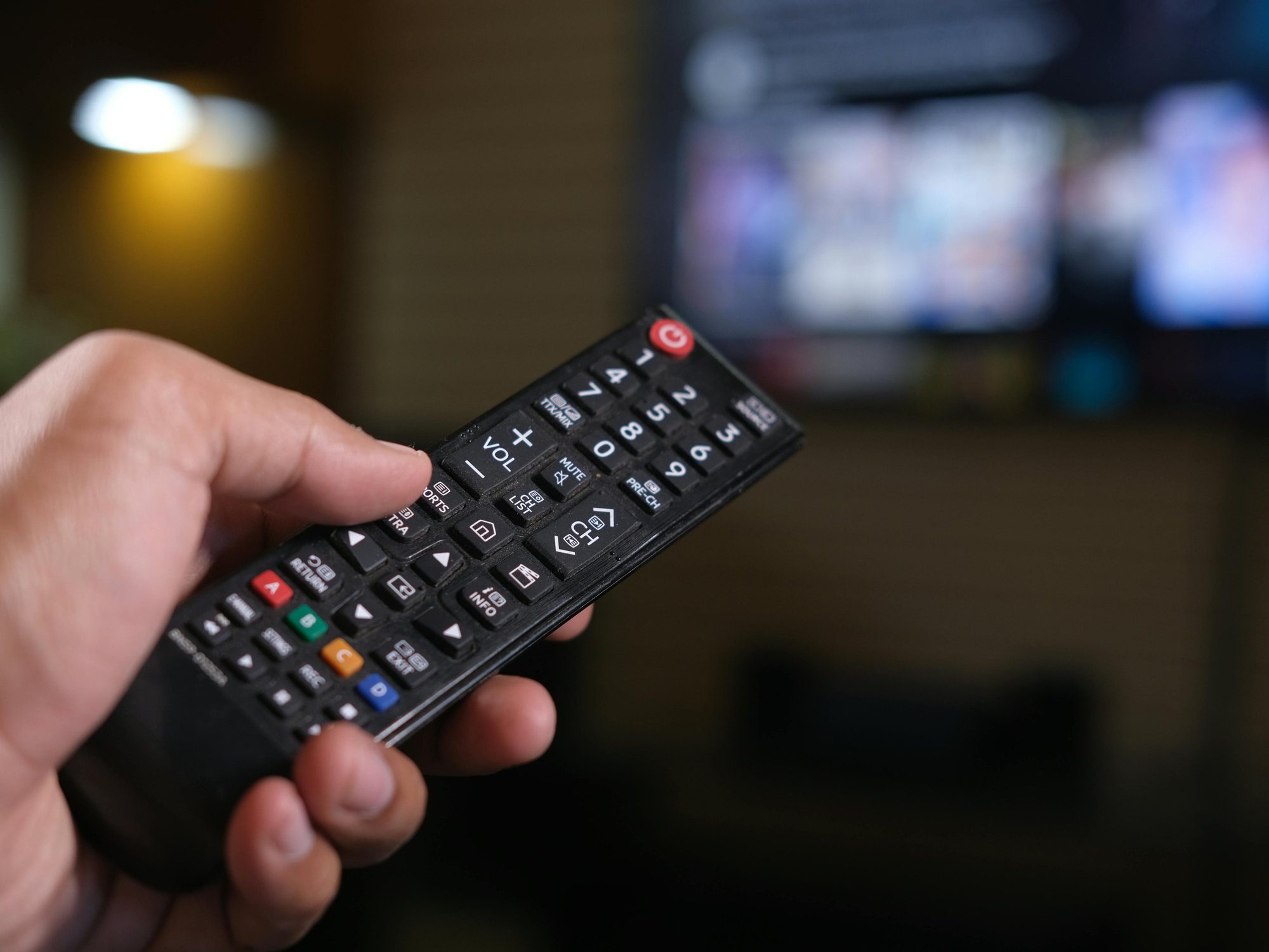Hand holding TV remote