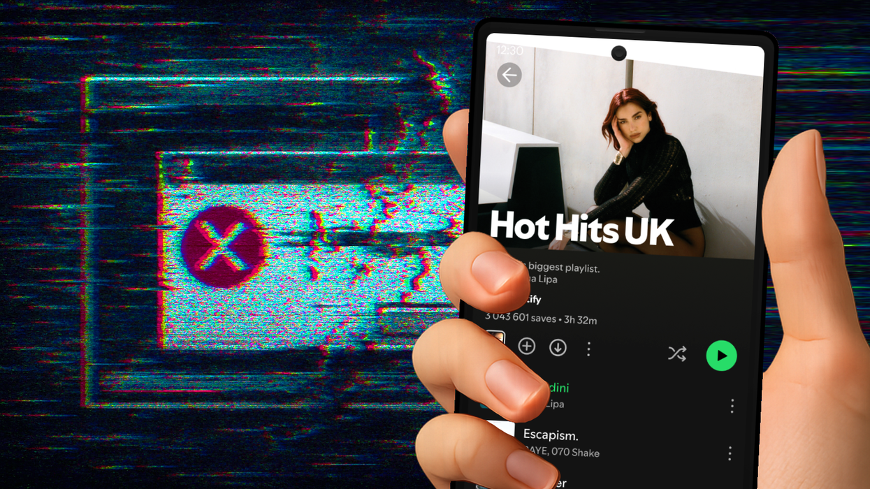 hand holds an Android smartphone with the Spotify app open and running