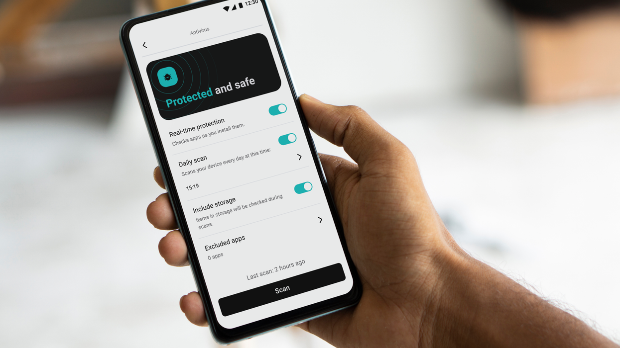 hand holds an iphone with surfshark vpn installed and connected