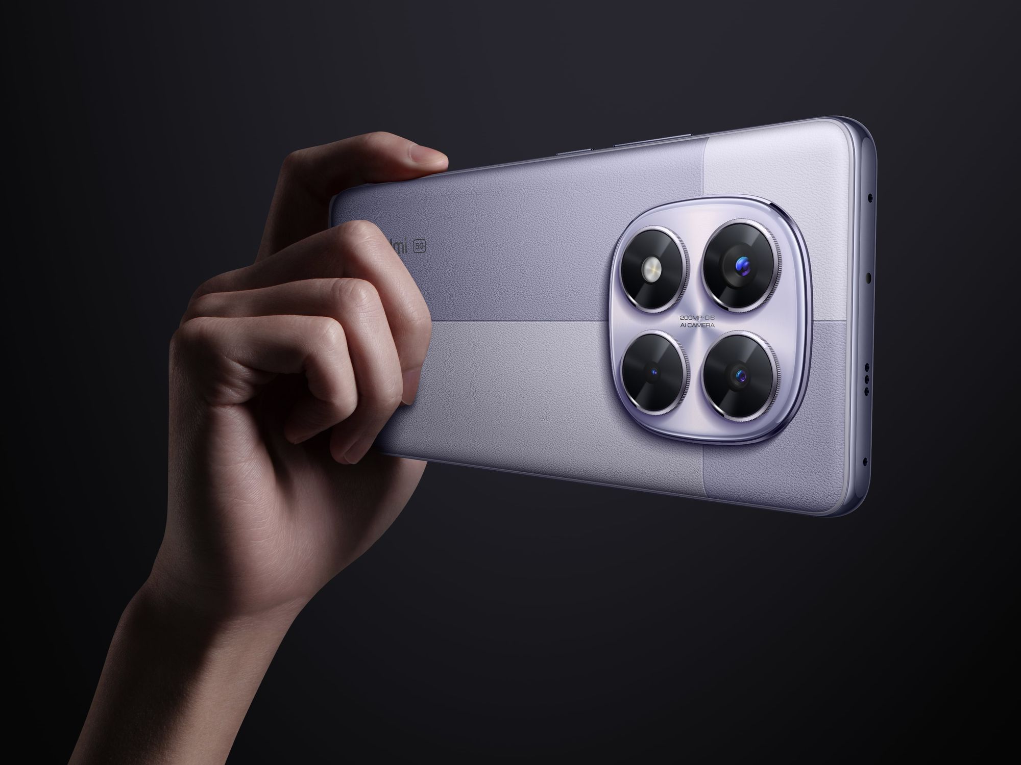 hand holds the purple Redmi Note 14 Pro smartphone to show off the camera sensor