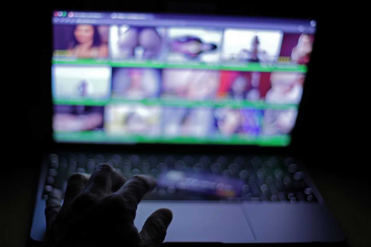 hand on a keyboard trying to access an adult website