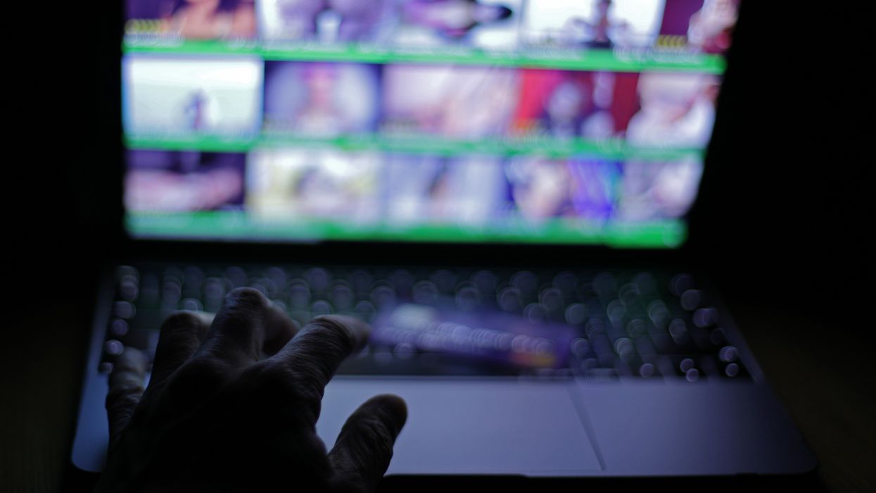 hand on a keyboard trying to access an adult website