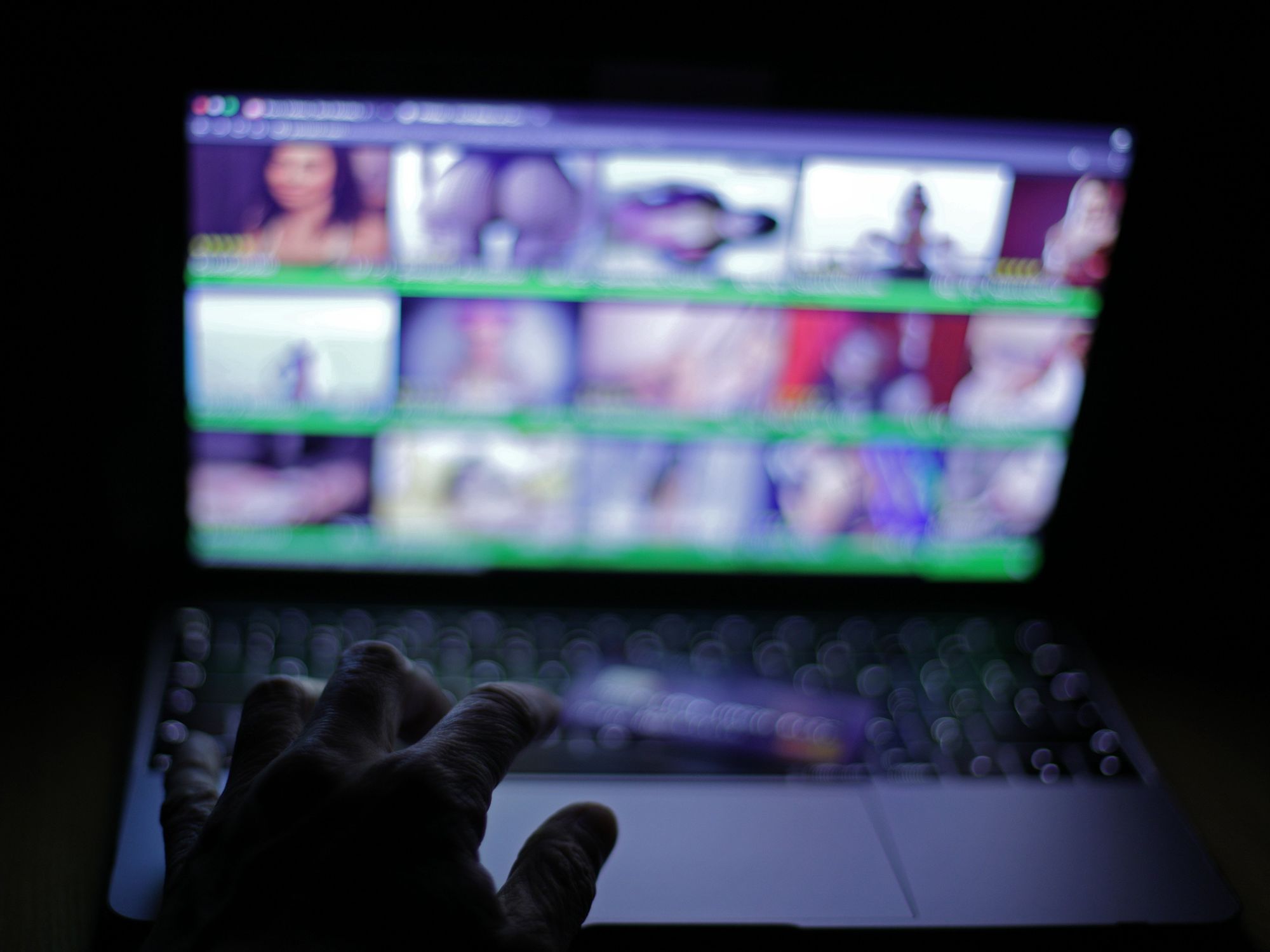 hand on a keyboard trying to access an adult website