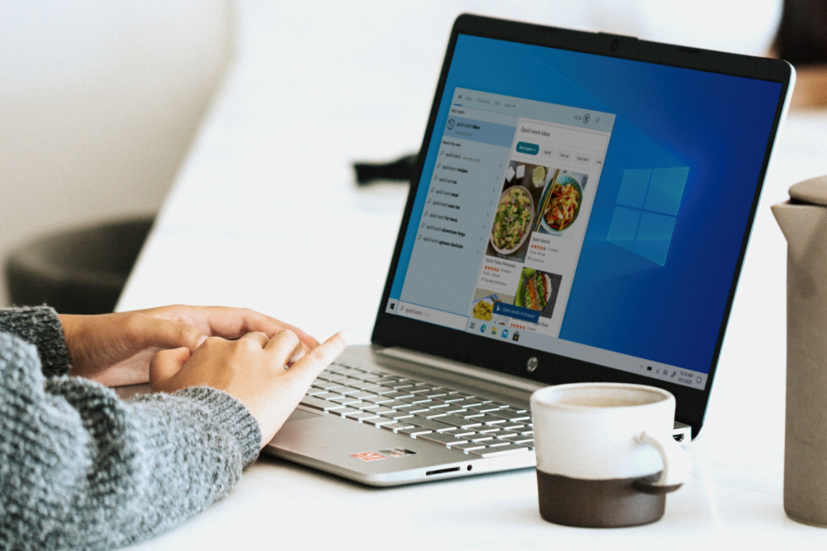 hand using a windows 10 laptop