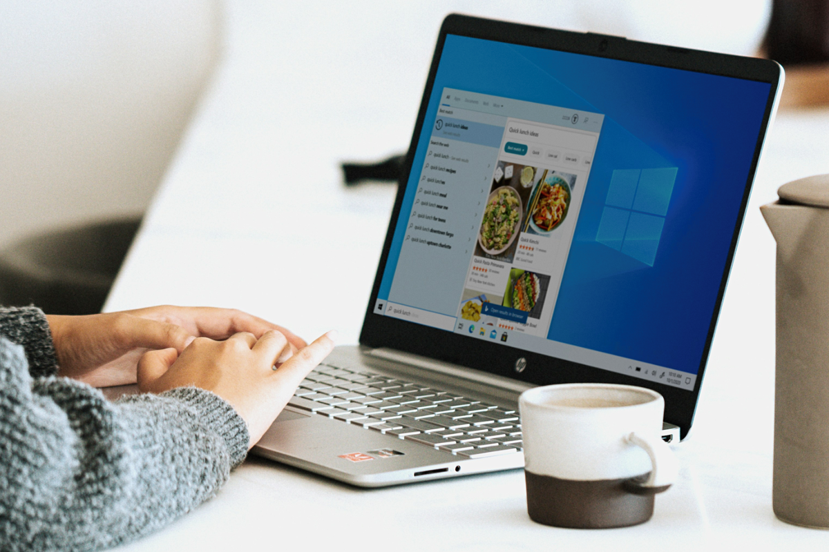 hand using a windows 10 laptop