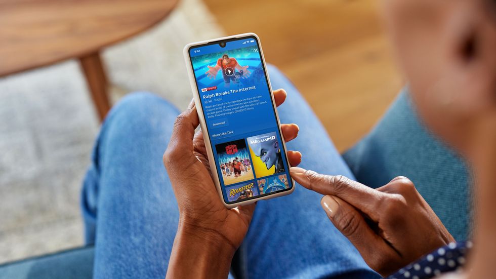 hand using the Sky Go app on an Android smartphone