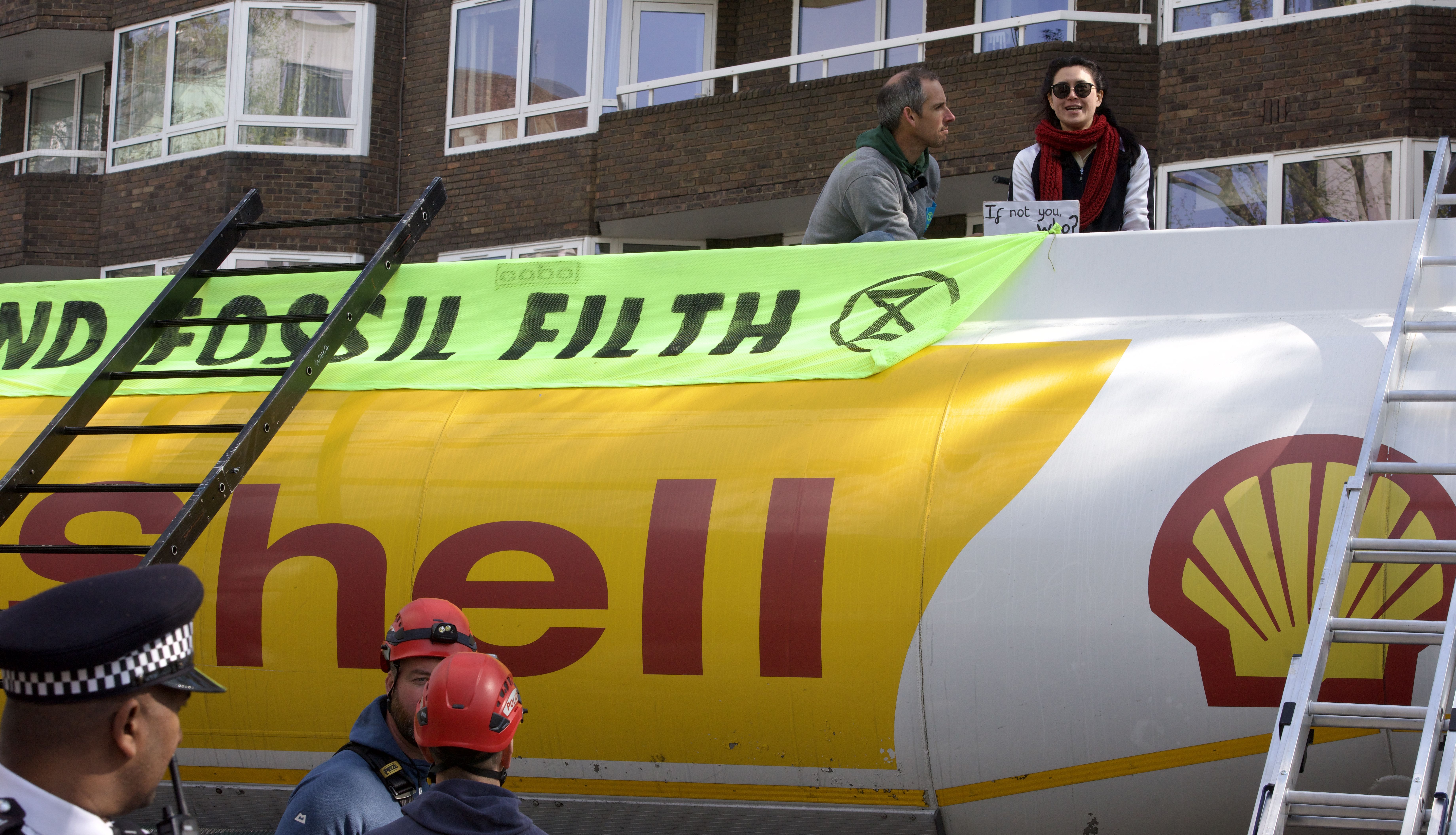 Handout photo issued by Extinction Rebellion of demonstrators taking part in protest with an oil tanker in Bayswater Road, London.