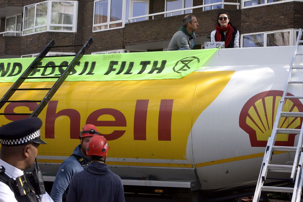 Handout photo issued by Extinction Rebellion of demonstrators taking part in protest with an oil tanker in Bayswater Road, London. Picture date: Saturday April 16, 2022.