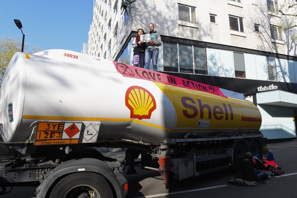 Handout photo issued by Extinction Rebellion of demonstrators taking part in protest with an oil tanker in Bayswater Road, London. Picture date: Saturday April 16, 2022.
