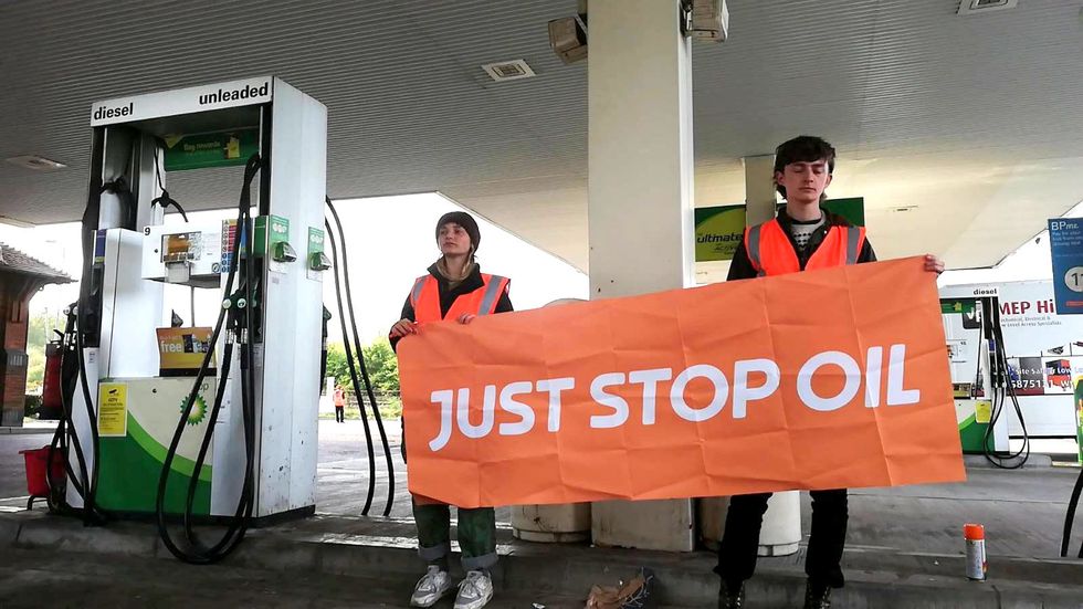 Handout photo issued by Just Stop Oil of campaigners staging a protest in the BP petrol garage at the Clacket Lane services on the M25 in Westerham, Kent. Picture date: Thursday April 28, 2022.