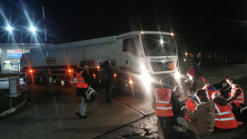 Handout photo issued by Just Stop Oil of their activists during their blockade of Esso Birmngham Fuel Terminal early on Friday (location not given). Picture date: Friday April 1, 2022.