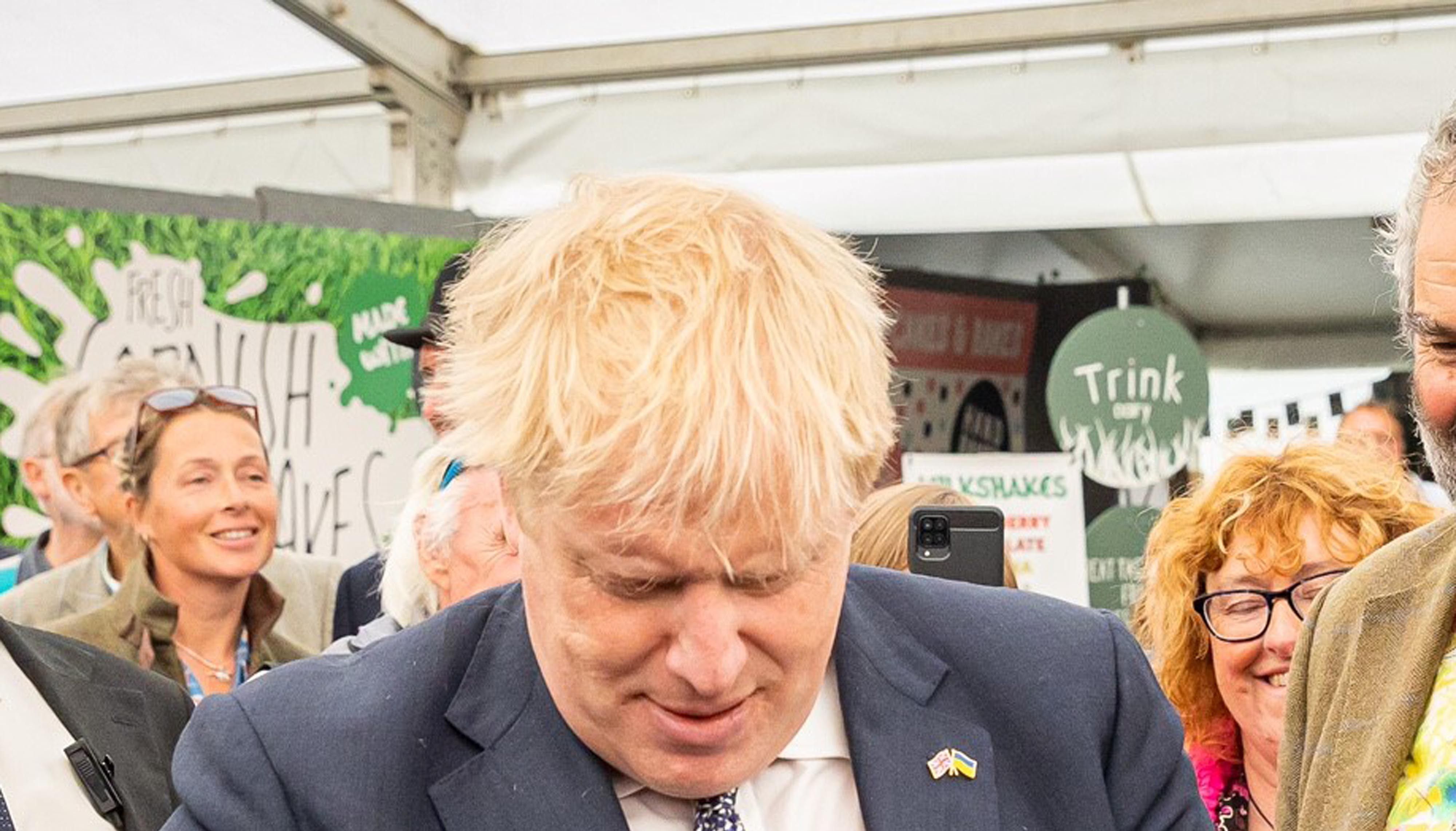 Handout photo of Prime Minister Boris Johnson buying a bottle of wine at the Royal Cornwall show at Whitecross near Wadebridge